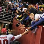 Eli Manning greets fans after the Giants win